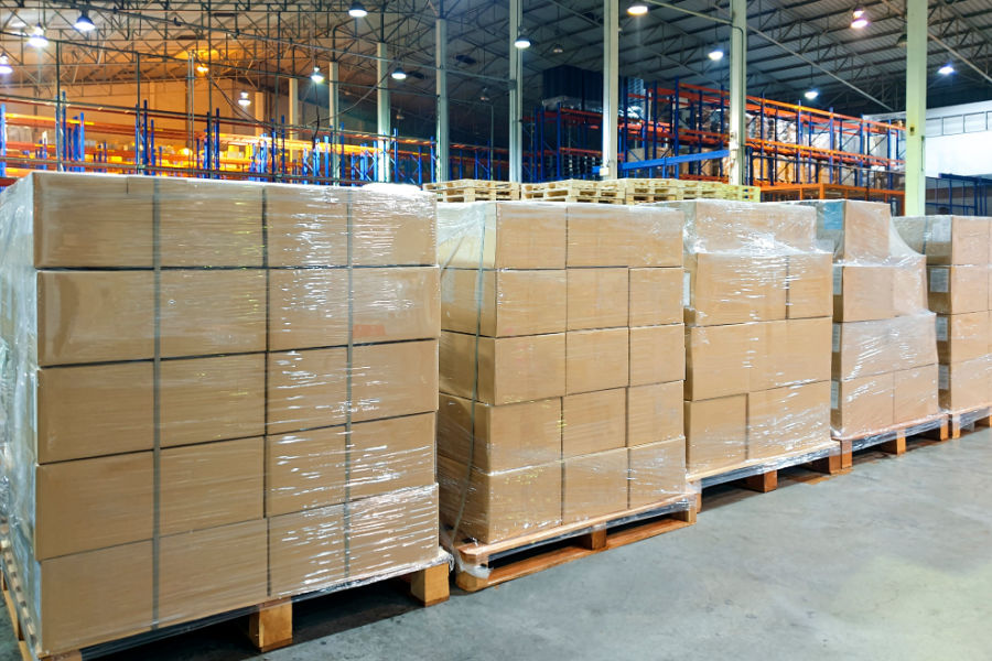 stack of food package boxes wrapping plastic on pallets in warehouse