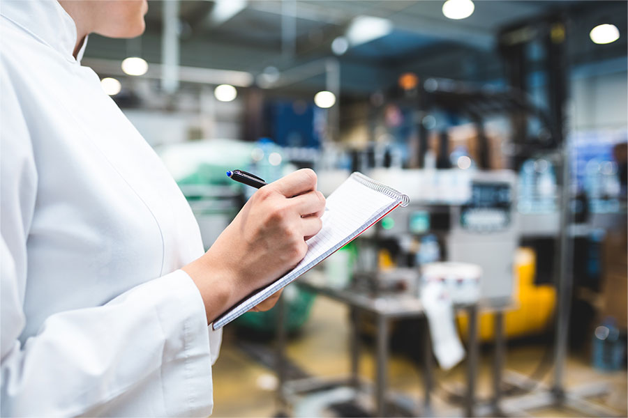 female worker checking the quality of packaging on factory