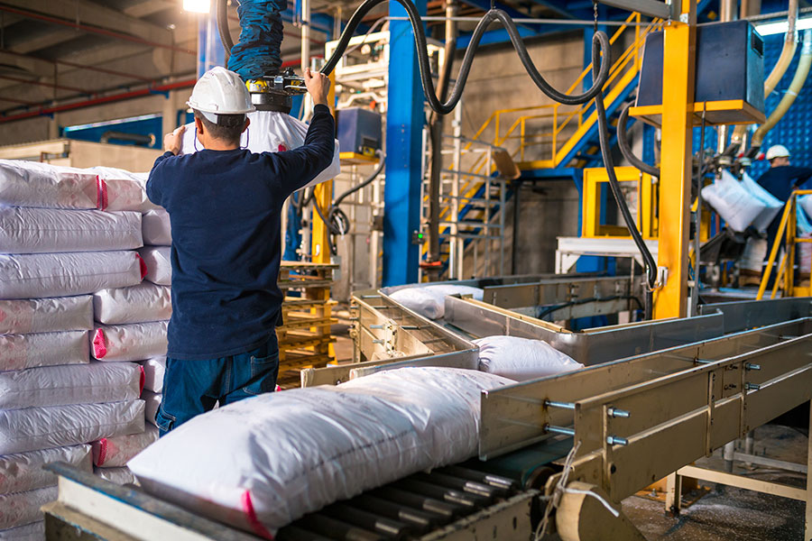 worker loading stack of sack at large warehouse