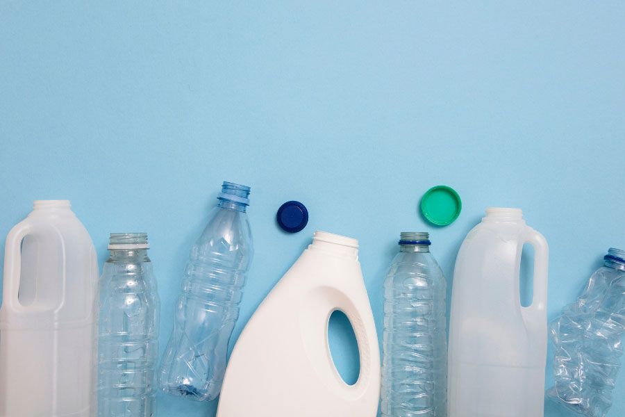 pe and pet bottles on blue background