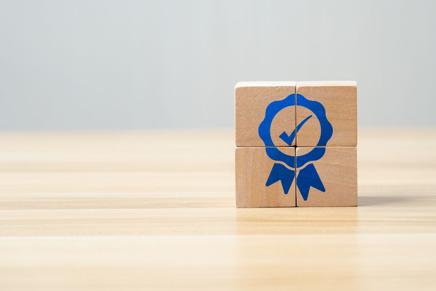 four wooden blocks with warranty symbol