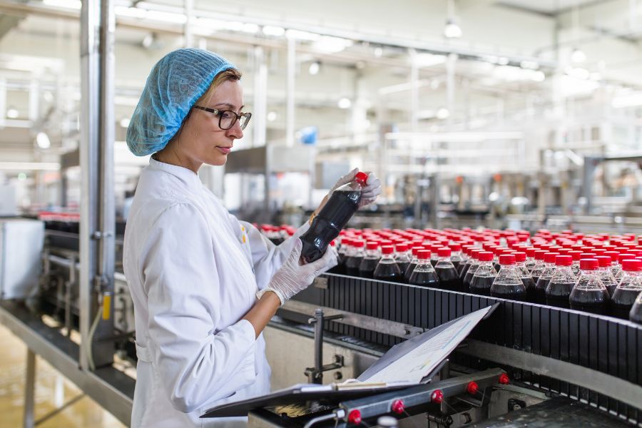 food quality control employee working on food conveyor