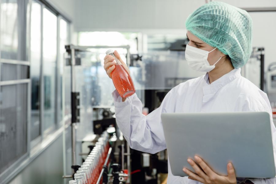 food safety inspector checking bottled product