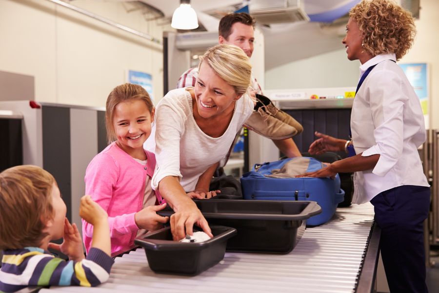 happy family at airport security scanner