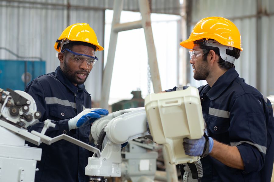 two engineer working with automatic palletizer maintenance