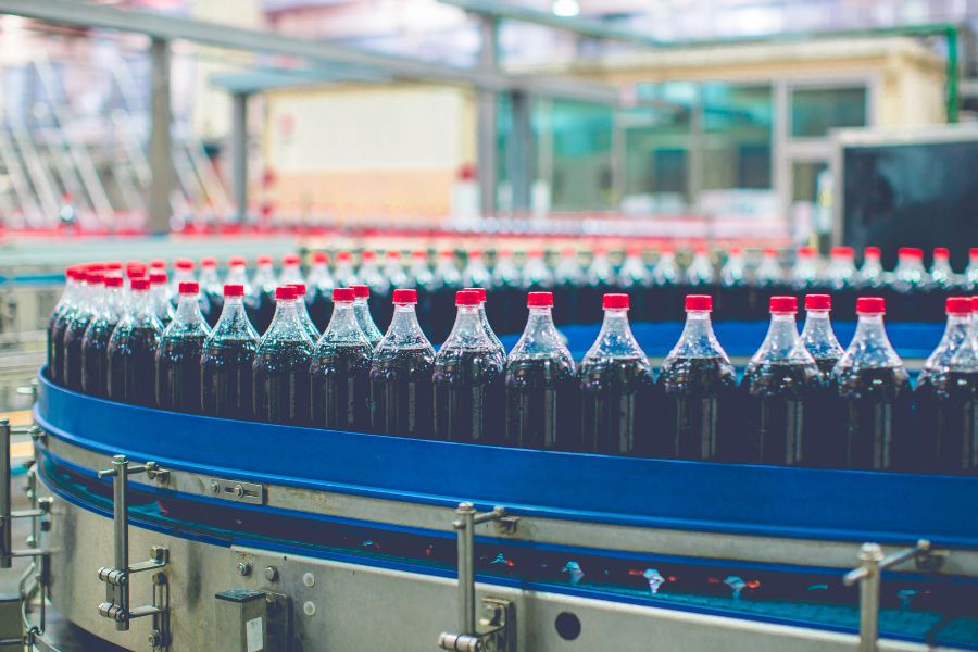 conveyor with soda bottles in beverage factory
