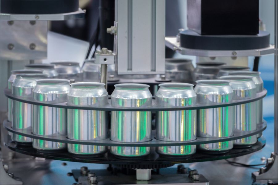 empty new cans moving in factory line on conveyor belt