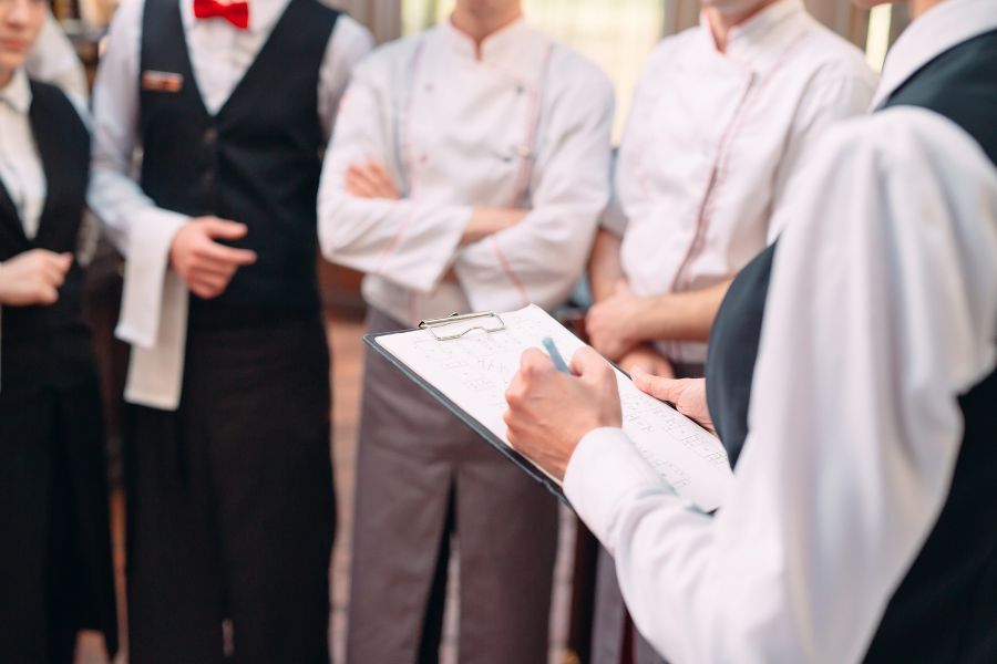 restaurant manager and kitchen meeting