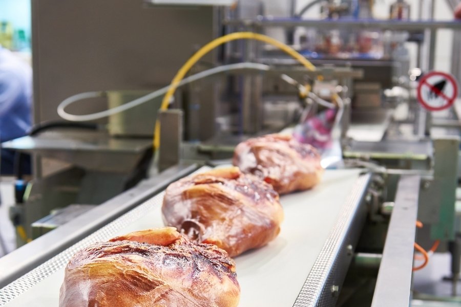 cured meat going to an inline x-ray