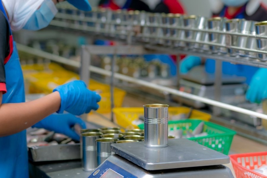 weighing cans in production line