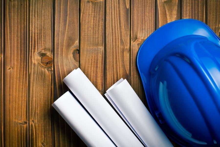 blue hard hat with document plans to install metal detector
