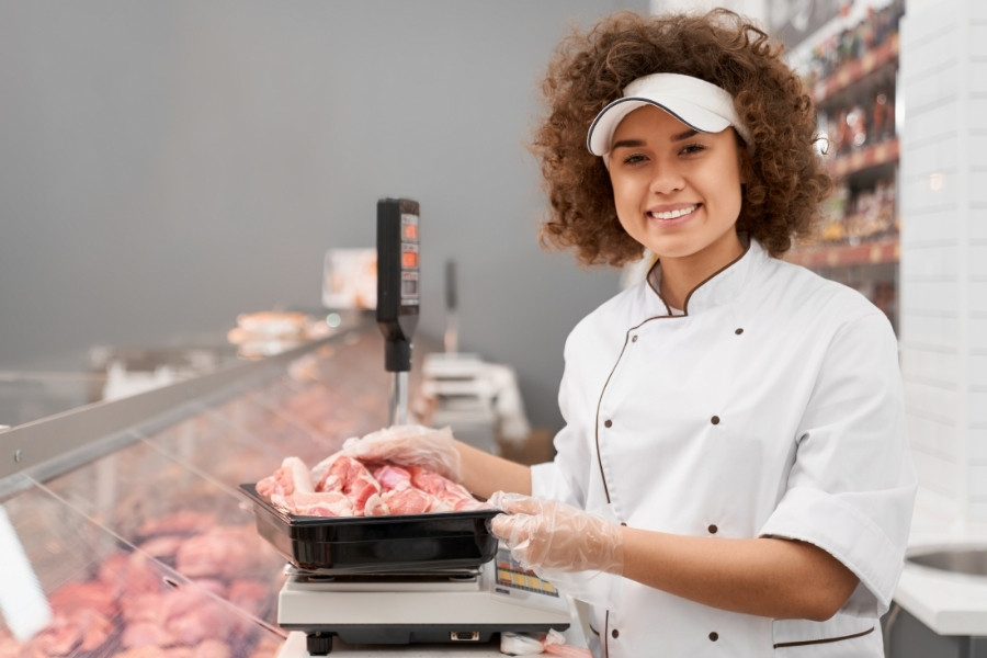 woman weighing meat products