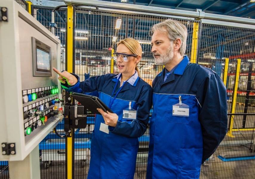 two engineers discussing metal detector settings