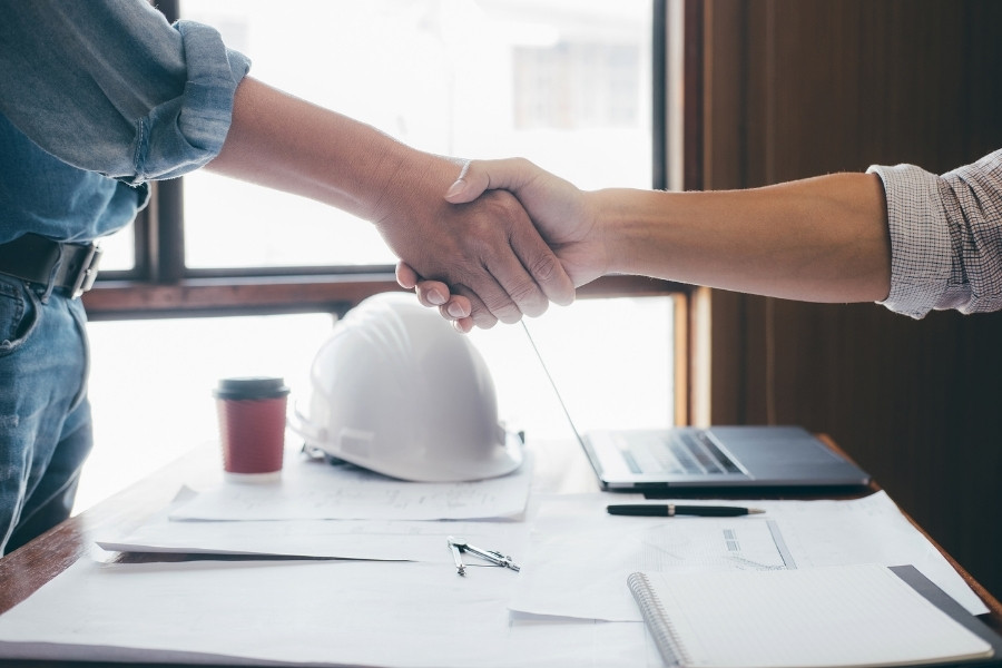 engineers shaking hands after successful food x-ray installation